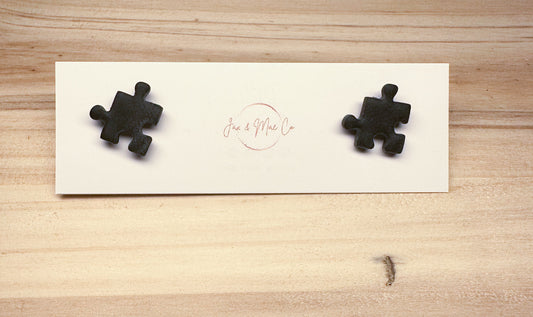 Black puzzle piece studs